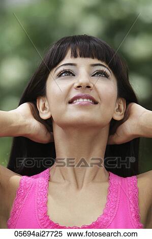Head shot of young Indian woman looking up with hands in her hair. View Large Photo Image Stock Photography - Head shot of young Indian woman looking up with hands in her hair.. Fotosearch