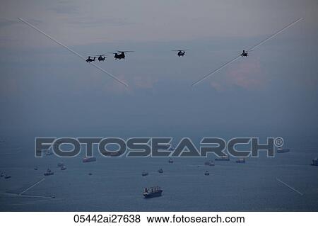Helicopters flying over the coast of Singapore View Large Photo Image Stock Photo - Helicopters flying over the coast of Singapore. Fotosearch