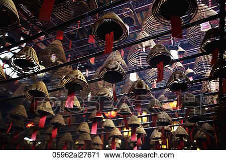 Incense coils hanging from ceiling of Man Mo Temple, Hong Kong View Large Photo Image Stock Image - Incense coils hanging from ceiling of Man Mo Temple, Hong Kong. Fotosearch