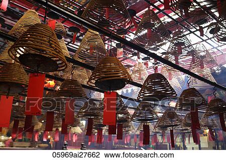 Incense hanging from ceiling in Man Mo temple, Hong Kong View Large Photo Image Stock Image - Incense hanging from ceiling in Man Mo temple, Hong Kong. Fotosearch