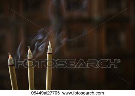 Stock Photography - Incense sticks burning with smoke. Fotosearch