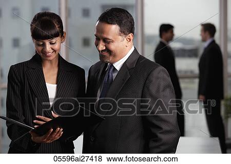 Indian colleagues discussing work View Large Photo Image Stock Photo - Indian colleagues discussing work. Fotosearch