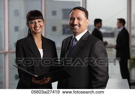 Indian man and woman in business attire smiling at camera. View Large Photo Image Stock Photo - Indian man and woman in business attire smiling at camera.. Fotosearch