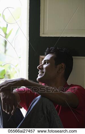 Indian man looking out window and smiling View Large Photo Image Stock Photo - Indian man looking out window and smiling. Fotosearch