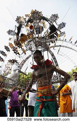 Stock Photo - Indian man wearing spiked head ornament during Thaipusam festival.. Fotosearch