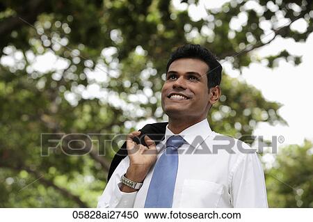 Indian man with coat over his shoulder smiling View Large Photo Image Stock Image - Indian man with coat over his shoulder smiling. Fotosearch