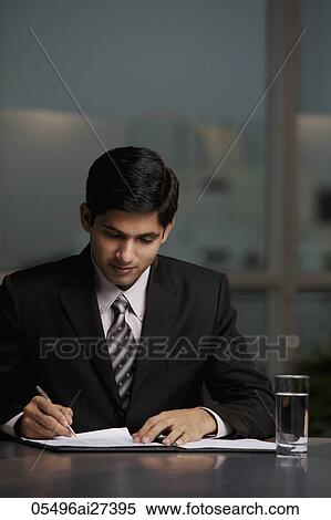 Indian man writing at table View Large Photo Image Stock Photography - Indian man writing at table. Fotosearch