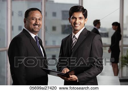 Indian men discussing business, colleagues in background View Large Photo Image Stock Image - Indian men discussing business, colleagues in background. Fotosearch