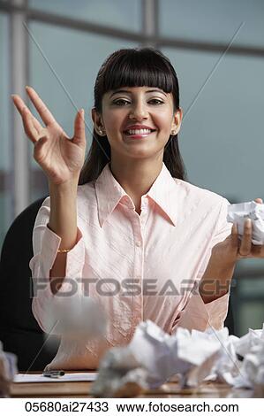 Indian woman throwing crumpled paper View Large Photo Image Stock Image - Indian woman throwing crumpled paper. Fotosearch