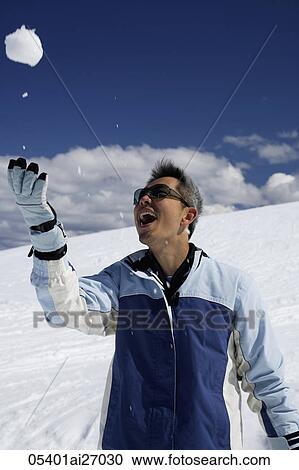 man throwing snow ball into air and smiling View Large Photo Image Stock Image - man throwing snow ball into air and smiling. Fotosearch