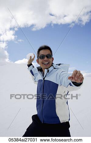 man throwing snowball and smiling View Large Photo Image Stock Image - man throwing snowball and smiling. Fotosearch