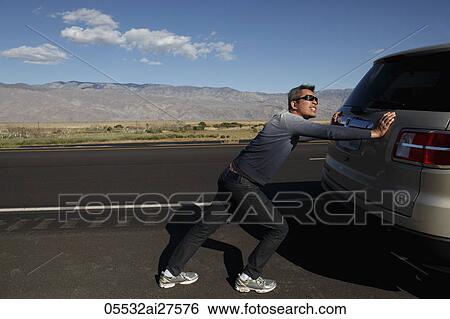 Mature man pushing car along the road. View Large Photo Image Stock Photograph - Mature man pushing car along the road.. Fotosearch
