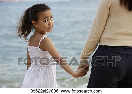 mother and daughter holding hands, daughter looking back View Large Photo Image Stock Photograph - mother and daughter holding hands, daughter looking back. Fotosearch