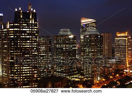 Stock Photo - Night view of office buildings and skyscrapers along Jalan Jend Sudirman, Jakarta. Fotosearch
