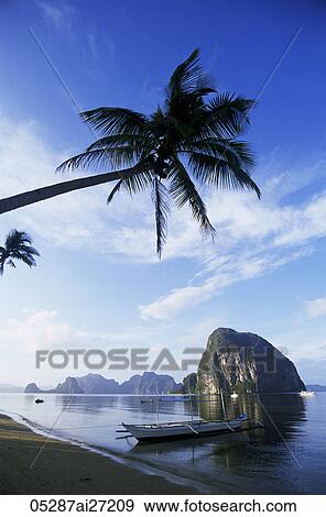 Philippines, Palawan, Bascuit Bay, El Nido, Outriggers on Tropical Beach View Large Photo Image Stock Photo - Philippines, Palawan, Bascuit Bay, El Nido, Outriggers on Tropical Beach. Fotosearch