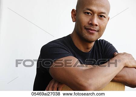 Portrait of bald Asian man with arms folded View Large Photo Image Stock Photo - Portrait of bald Asian man with arms folded. Fotosearch
