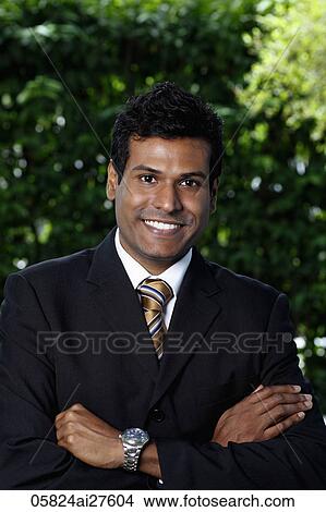 Picture - Portrait of Indian man folding arms and smiling at camera. Fotosearch