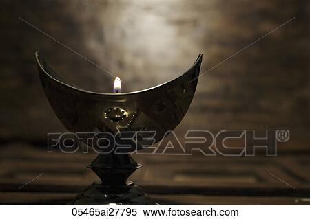 Silver cresent candle holder with lit candle View Large Photo Image Stock Photography - Silver cresent candle holder with lit candle. Fotosearch