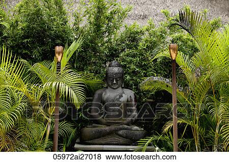 stone buddha statue surrounded by palm trees View Large Photo Image Stock Photo - stone buddha statue surrounded by palm trees. Fotosearch