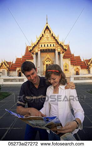 Stock Image - Thailand, Bangkok, Wat Benchamabophit, Tourist Couple in the Marble Temple. Fotosearch