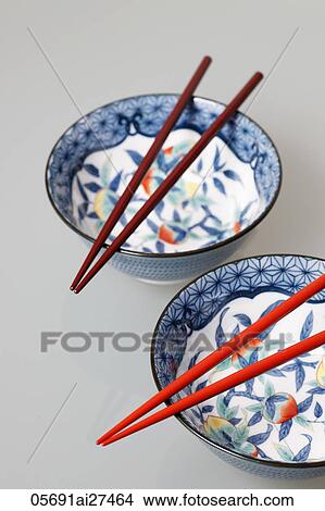 Two China bowls with chopsticks on top View Large Photo Image Picture - Two China bowls with chopsticks on top. Fotosearch