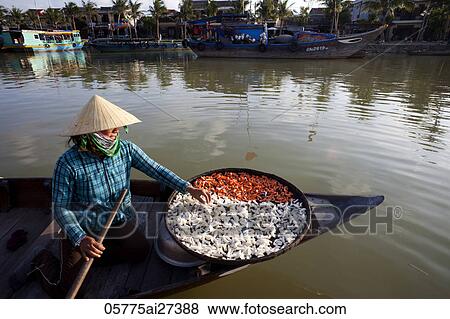 Stock Photo - Vietnam, Hoi An, Boat Woman and Dried Products. Fotosearch