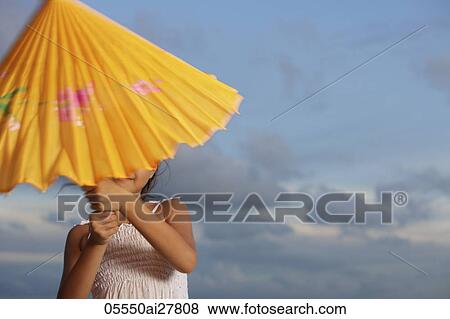 young girl trying to open up yellow umbrella View Large Photo Image Stock Photo - young girl trying to open up yellow umbrella. Fotosearch