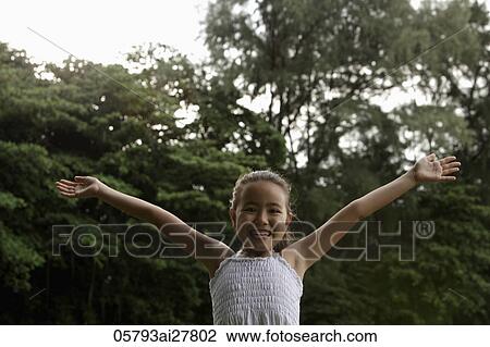 young girl with ams outstretched smiling at camera View Large Photo Image Stock Image - young girl with ams outstretched smiling at camera. Fotosearch