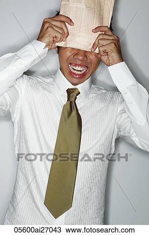 young man hitting his head with newspaper and yelling View Large Photo Image Stock Image - young man hitting his head with newspaper and yelling. Fotosearch