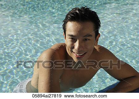Stock Photo - Young man in swimming pool smiling. Fotosearch