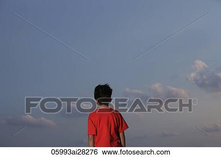 back view of young boy with red shirt looking at sky View Large Photo Image Stock Photograph - back view of young boy with red shirt looking at sky. Fotosearch