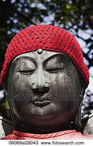 Buddhist stone statue wearing a red hat. Asakusa Kannon Temple, Japan View Large Photo Image Stock Image - Buddhist stone statue wearing a red hat. Asakusa Kannon Temple, Japan. Fotosearch