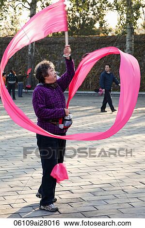 China, Beijing, Summer Palace Park, Woman Exercising with pink ribbon View Large Photo Image Stock Photograph - China, Beijing, Summer Palace Park, Woman Exercising with pink ribbon. Fotosearch