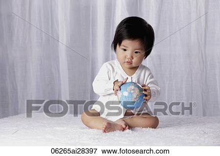Stock Photo - Chinese baby holding small globe. Fotosearch
