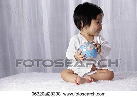 Chinese baby holding small globe View Large Photo Image Stock Photo - Chinese baby holding small globe. Fotosearch