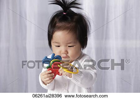 Chinese baby holding toy key ring View Large Photo Image Stock Photograph - Chinese baby holding toy key ring. Fotosearch