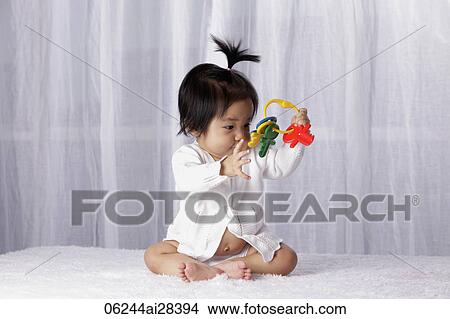 Chinese baby looking at toy key ring View Large Photo Image Picture - Chinese baby looking at toy key ring. Fotosearch