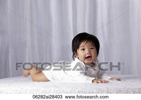 Chinese baby on tummy smiling View Large Photo Image Stock Image - Chinese baby on tummy smiling. Fotosearch