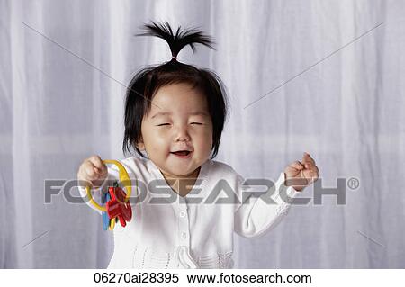 Stock Photography - Chinese baby smiling with eyes closed. Fotosearch
