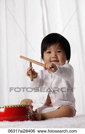 Chinese baby with red drum holding drum sticks View Large Photo Image Stock Photograph - Chinese baby with red drum holding drum sticks. Fotosearch