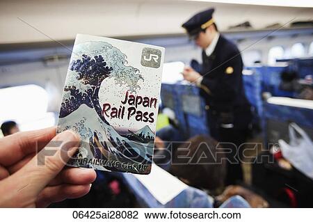 Close up of hand holding a Rail Pass inside the bullet train with the conductor in background. View Large Photo Image Stock Image - Close up of hand holding a Rail Pass inside the bullet train with the conductor in background.. Fotosearch