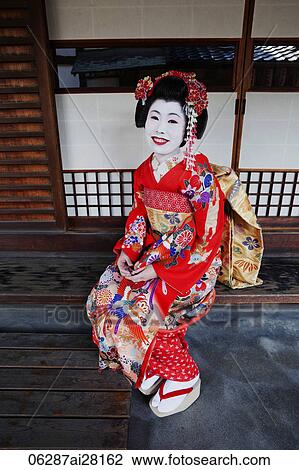 Geisha in red Kimono sitting in front of house View Large Photo Image Stock Image - Geisha in red Kimono sitting in front of house. Fotosearch