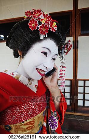 Geisha talking on phone and smiling View Large Photo Image Stock Image - Geisha talking on phone and smiling. Fotosearch