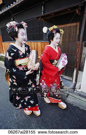 Stock Photography - Geishas walking down the street in traditional Japanese clothing. Fotosearch