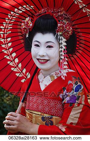 Head shot of Japanese woman in traditional makeup holding red umbrella. View Large Photo Image Stock Image - Head shot of Japanese woman in traditional makeup holding red umbrella.. Fotosearch
