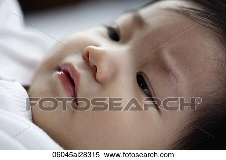 Stock Photography - head shot of sleepy baby. Fotosearch