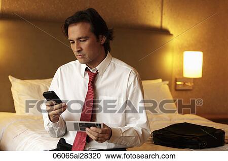 man looking at ticket and holding phone View Large Photo Image Stock Image - man looking at ticket and holding phone. Fotosearch