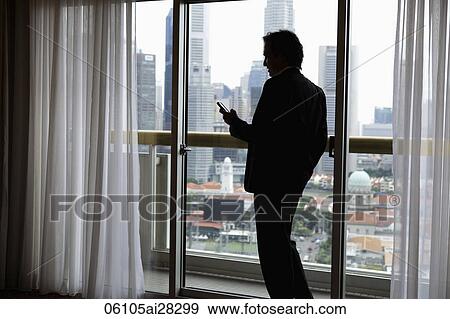 Profile of businessman near window with city as background View Large Photo Image Stock Photo - Profile of businessman near window with city as background. Fotosearch