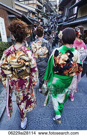 Rear view of women dressed in Kimonos walking down the street. Japan, Kyoto. View Large Photo Image Picture - Rear view of women dressed in Kimonos walking down the street. Japan, Kyoto.. Fotosearch