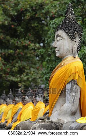 Picture - Side view of stone Buddhas at Wat Yai Chaya Mongkol Temple, Thailand. Fotosearch